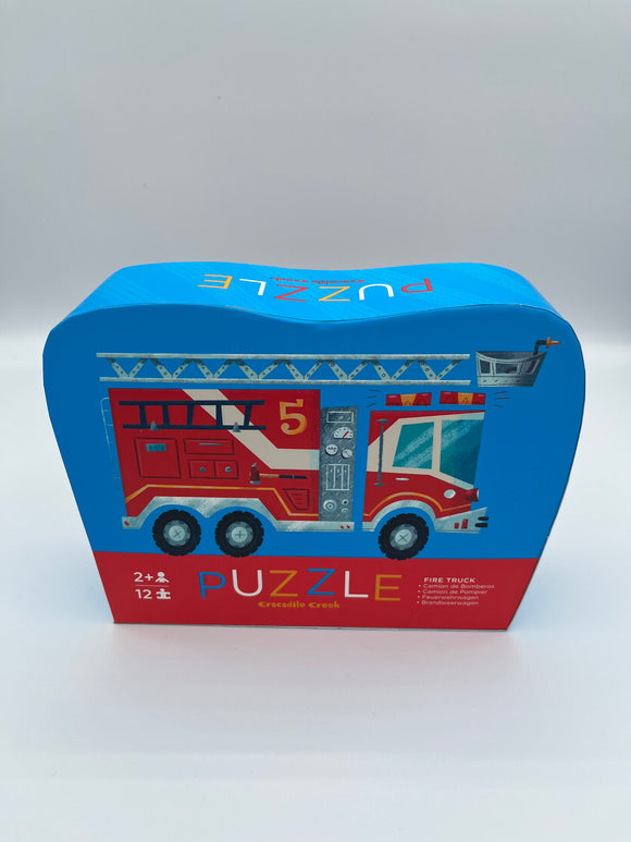 The firetruck Crocodile Creek 12 piece puzzle. The box is blue and red with a red firetruck on the front.