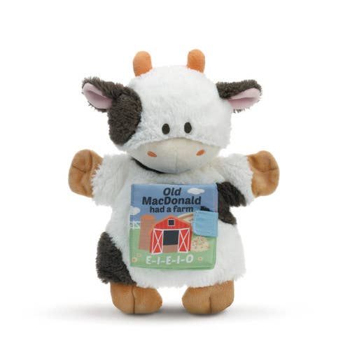 Plush cow toy with a 'Old MacDonald had a farm' t-shirt on a white background