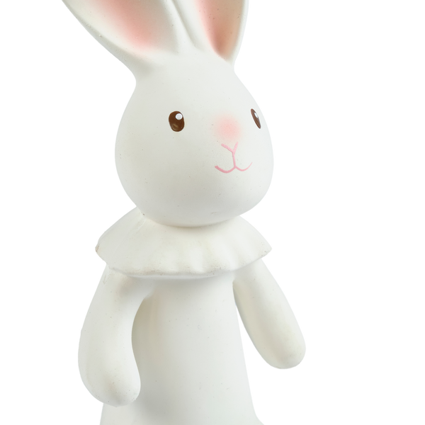 White rabbit figurine with pink inner ears on a white background