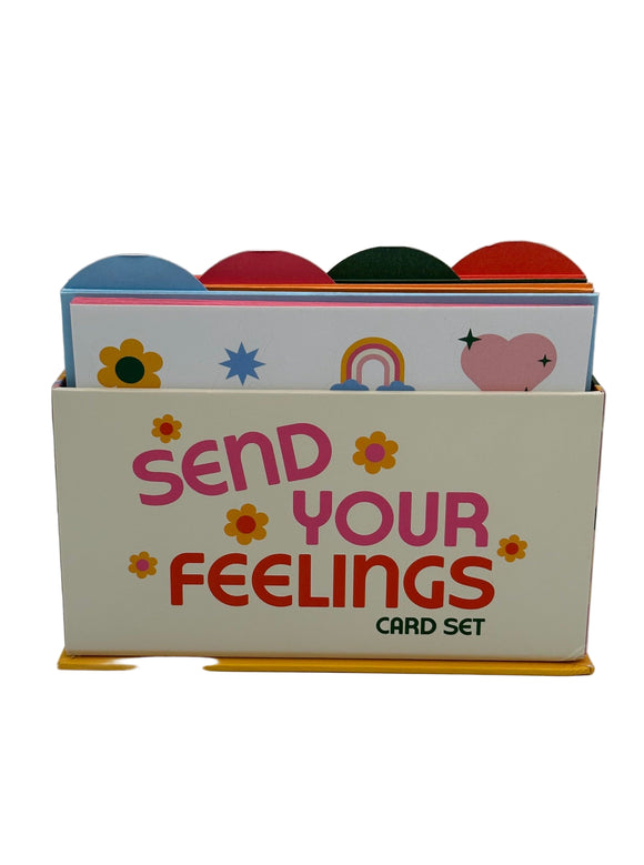 The Ban-do Wellness Card Set. It shows a cream box with pink writing that says, "Send your feelings card set" with yellow flowers. There are tabs along the top in blue, pink, green, and orange.