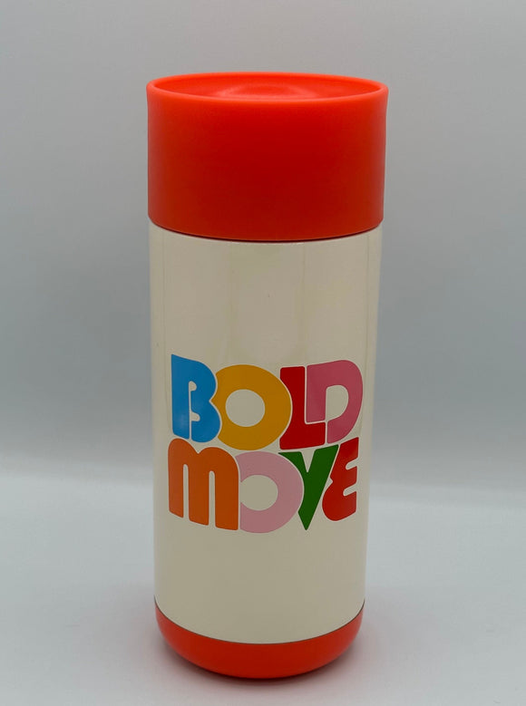 The Ban-do Bold Move mug. It is cream with a red lid and red bottom with writing that says, "Bold Move" with alternating blue, yellow, red, dark pink, orange, light pink, and green letters.