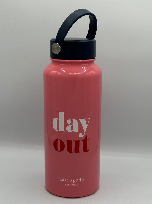 Pink metal water bottle with a navy blue lid with a carrying strap. The water bottle reads, "day out" with day in white and out in red. The bottom says, "kate spade, New York" in white.
