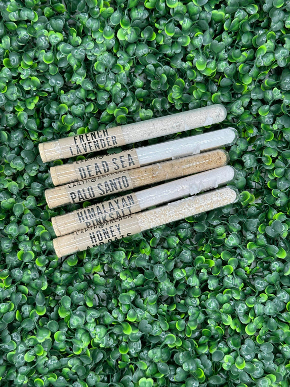 The bath salt tubes in a line. The scents are french lavender, dead sea, palo santo, himalayan pink salt, and honey and oats.