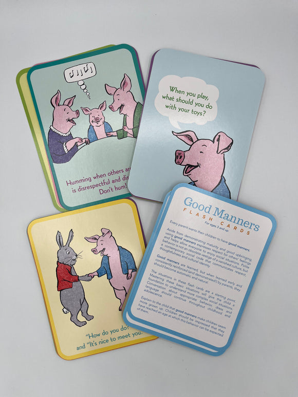 Examples of the cards inside the Eeboo Good Manners Cards box. Two of the cards show the backside which contains animals showcasing good manners with a description of the good manner, one contains instructions for the cards, and one contains the front side that has an animal asking what you should do in a certain scenario.