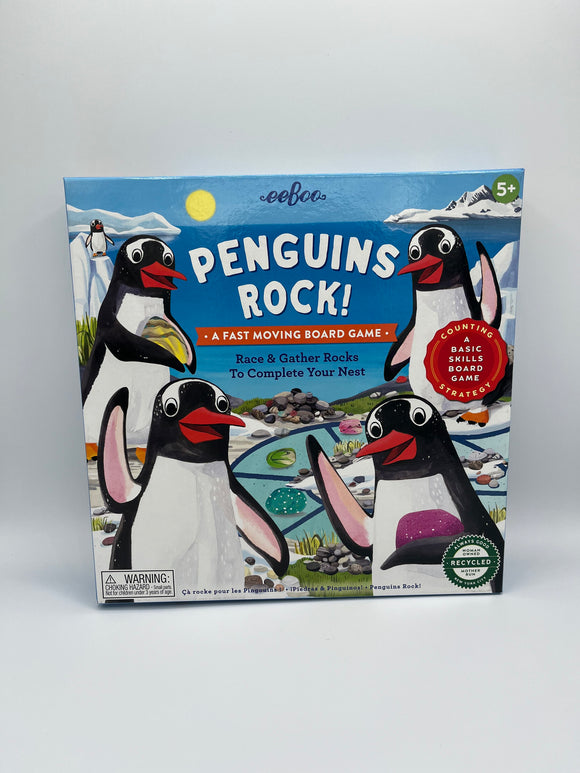 The front of the Eeboo Penguins Rock Board Game box. The box is blue with 4 penguins waving, and it says, "Penguins Rock! A Fast Moving Board Game, Race & Gather Rocks to Complete Your Nest".