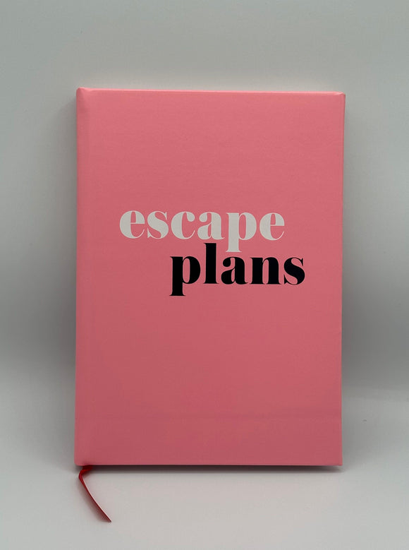 Pink planner cover that says, "escape plans" with escape in white and plans in black. There is a red bookmark string coming out of the bottom.