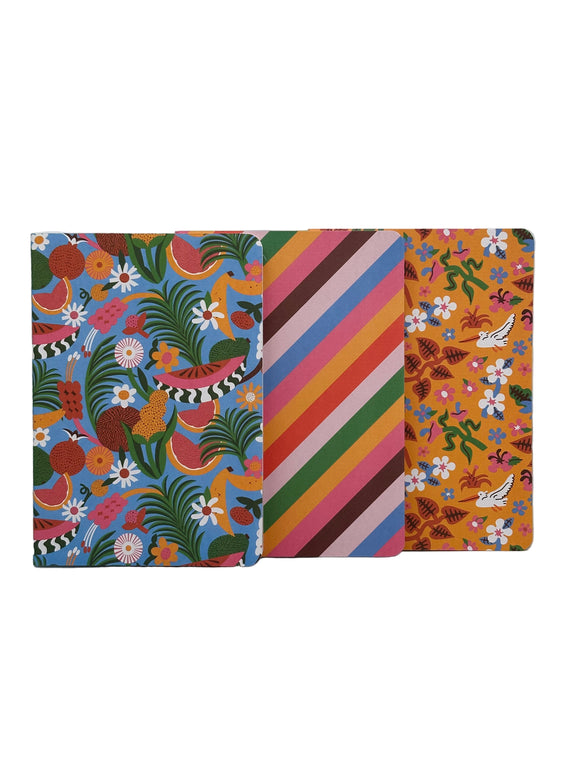 The covers of each of the three Ban-do fruity notebook set. One is blue with leaves, watermelons, and yellow and white flowers, one has pink, blue, brown, yellow, green, and red diagonal stripes, and one is yellow with red leaves, green stems, white birds, and white and pink flowers.