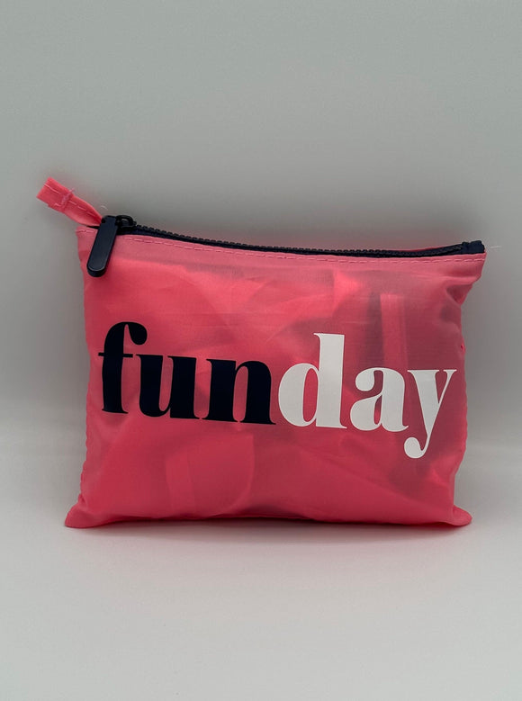 Pink tote folded into its pink pouch that says, "funday" with fun in navy and day in white.