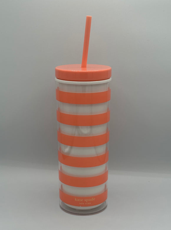 Peach and white stripe plastic tumbler. It has a peach lid with a peach straw and says, "kate spade, New York" in gold at the bottom.