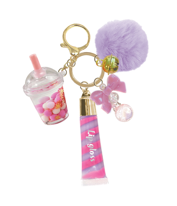 Keychain with a boba cup, lip gloss, and pom-pom on a white background