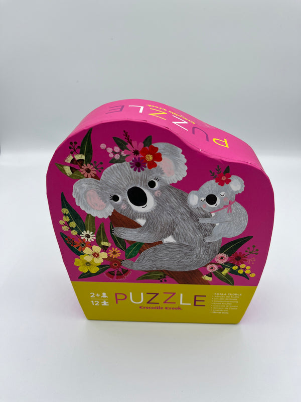 The koala Crocodile Creek 12 piece puzzle. The box is pink with two koalas and flowers on the front.