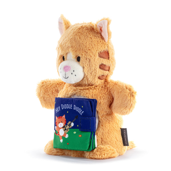 Plush toy cat holding a book on a white background