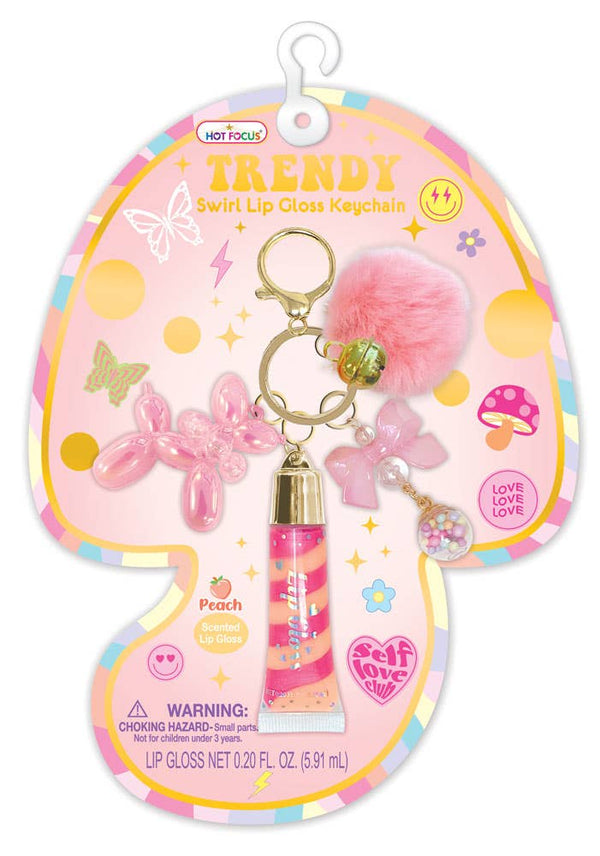 Pink lip gloss keychain with balloon dog and bow charms on a colorful Trendy packaging.