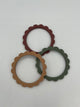 The dried thyme, berry, and natural rings out of the pack. In the back is the berry (maroon) ring, on the right is the dried thyme (sage green) ring, and on the left is the natural (brown) ring.