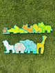 Back of the Hape alphabet and animal parade. The animals all form a line, but they are split into two. They each have different letters on the back to create the whole alphabet in order when the pieces are connected. From left to right, there is a brown monkey with an a, a yellow alligator with a b,c,d, an orange tiger with e, f, g, a yellow lion with h, i, j, a green rhino wiht k, l, m, a grey zebra with n, o, p, a grey hippo with q, r, s, blue elephant with t, u, v, w, and a yellow giraffe with x, y, z.