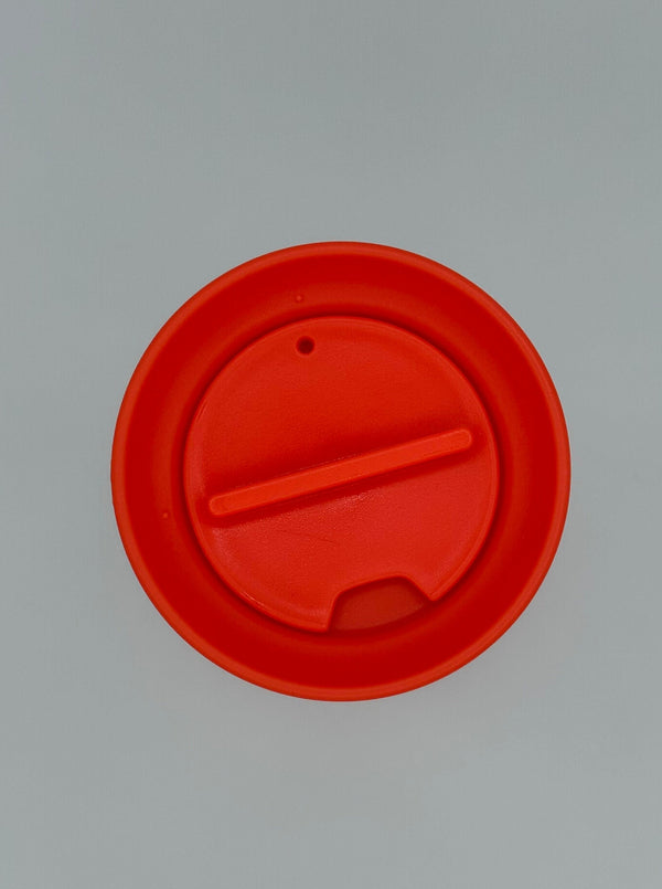 The top of the Ban-do Bold Move mug. It shows the red lid that spins to open the mouth opening.