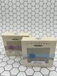 Both scents of the Finchberry Earth Soaps. Each are in tan boxes that say, "Finchberry" in black writing across the top and have a picture of the soap with the scent underneath. In front is the "Breeze" scent which is a grey soap with a blue stripe through the middle. In the back is the Valley scent which is a tan soap with a purple stripe through the middle.