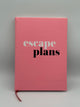 Pink planner cover that says, "escape plans" with escape in white and plans in black. There is a red bookmark string coming out of the bottom.
