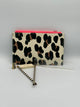 Tan, black, and brown cheetah print pencil pouch with a neon pink zipper. There is a small pencil sharpener, a tan eraser, two tan and black strip pencils, and a clear ruler with gold markings.