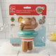 Hape Swimmer Teddy in the package. Along the top is a red strip that says, "Swimmer Teddy Wind-Up Toy, Teddy geht planschen". Behind the teddy is a bathtub scene with white tile and blue water and bubbles. In the top right corner is an image of a baby playing with the teddy in the bath. The teddy is brown with a red and white stripe bathing suit and a teal inner tube around it.