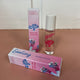 In the back there is the pink Honestly Margo Roller Girls Lip Gloss box next to the lip gloss. The box is pink and says, "Roller Girls, Roll-on Lipgloss", and the lip gloss is in a clear tube with a white cap and says, "Roller Girls" in pink. In the front the box is laying on its side. On the top it says, "Destiny, Bubblegum", and on the side it says, "Roller Girls, Roll-on Lipgloss".